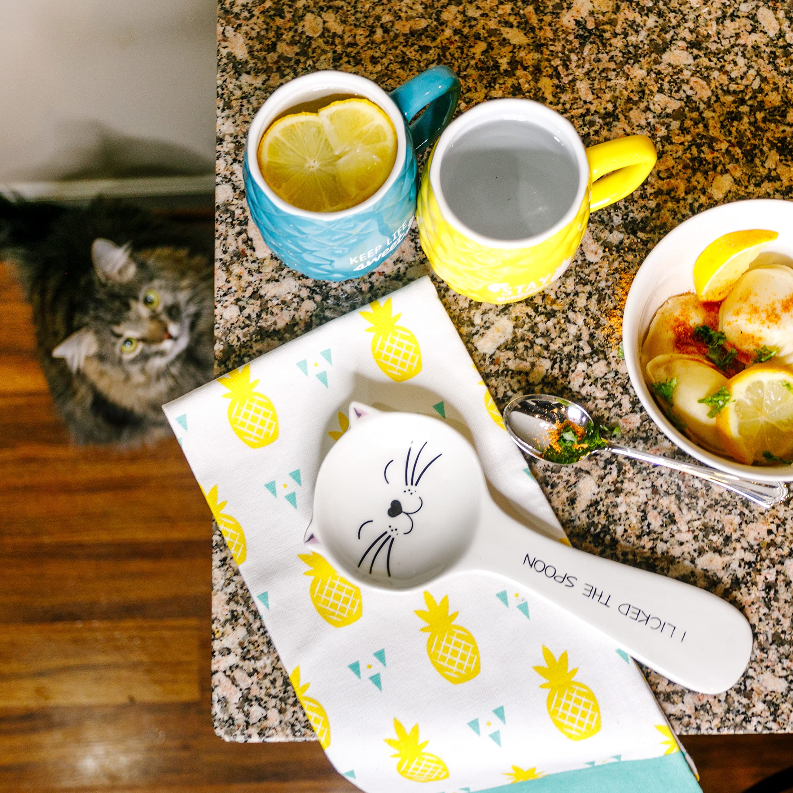 Pavilion Gift Company cat spoon rest sits on a kitchen counter as a cute decor piece.