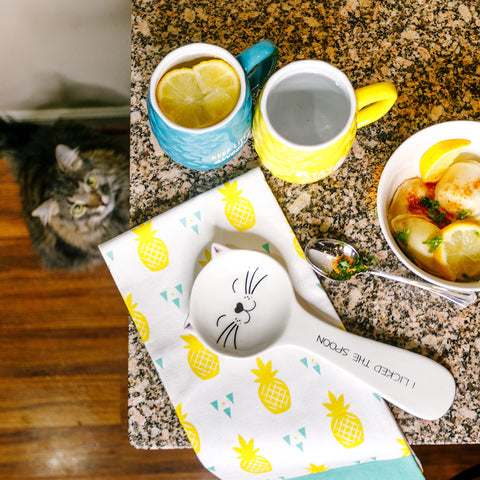 Pavilion Gift Company cat spoon rest sits on a kitchen counter as a cute decor piece.