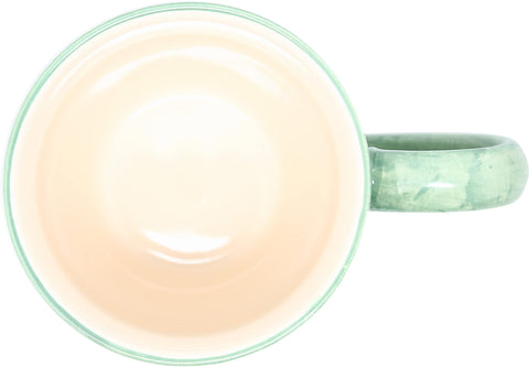 Pavilion Gift Co steaming coffee from green mug on counter