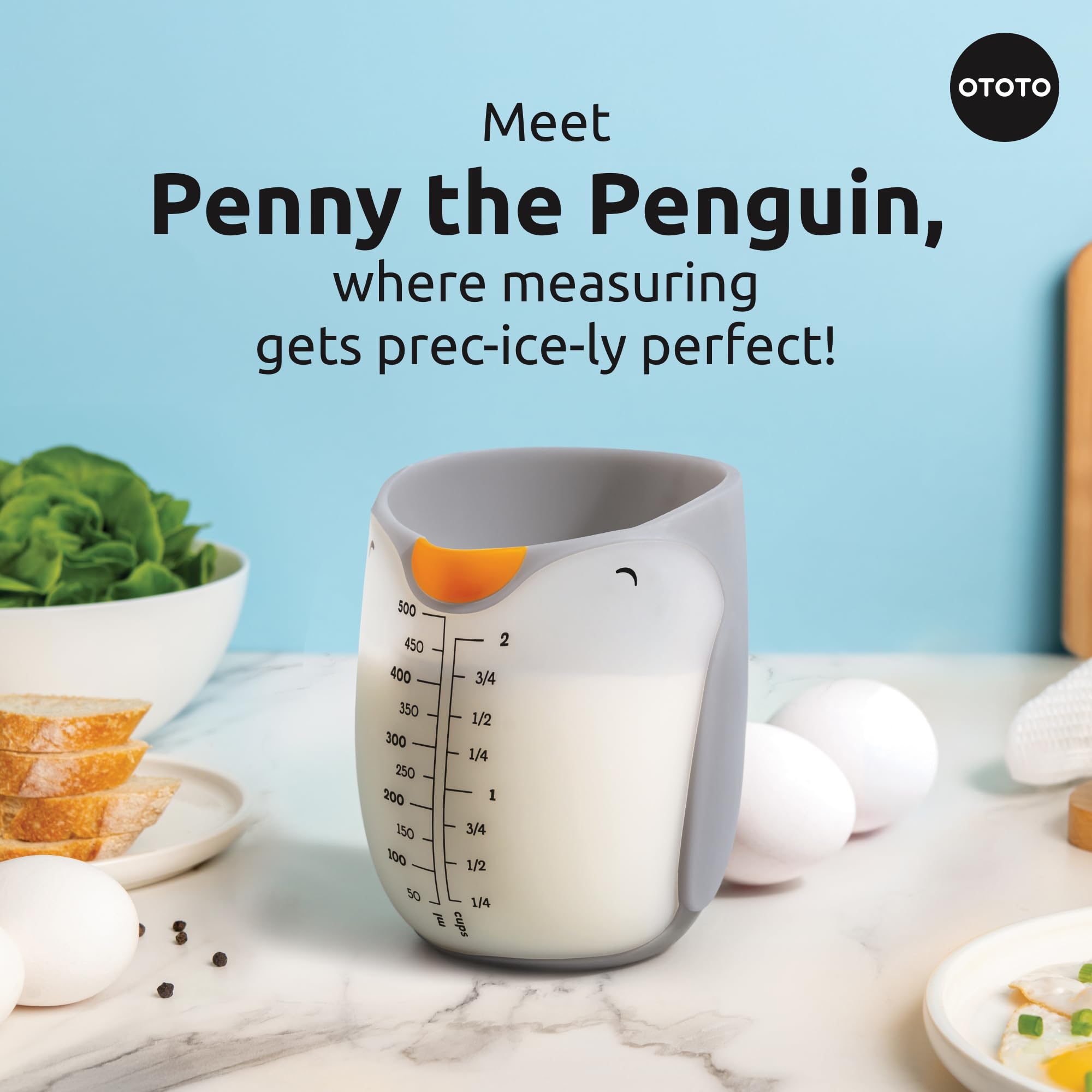 Penny Penguin measuring cup stands on the counter for spill-free pouring.