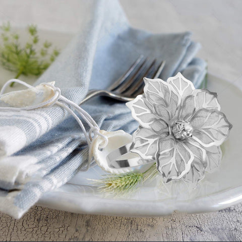 Wedding table setting featuring Picowe napkin rings with floral design in silver.