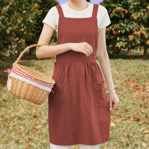 Pinknoke apron pockets closeup highlights convenient storage for utensils and brushes.