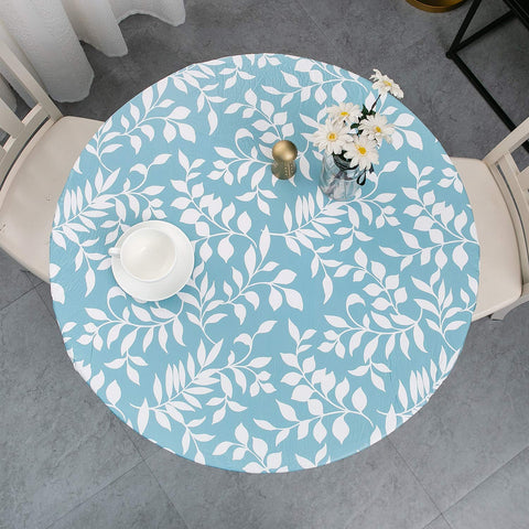 Pioggia round tablecloth with elastic fit protects 45-56 inch tables.