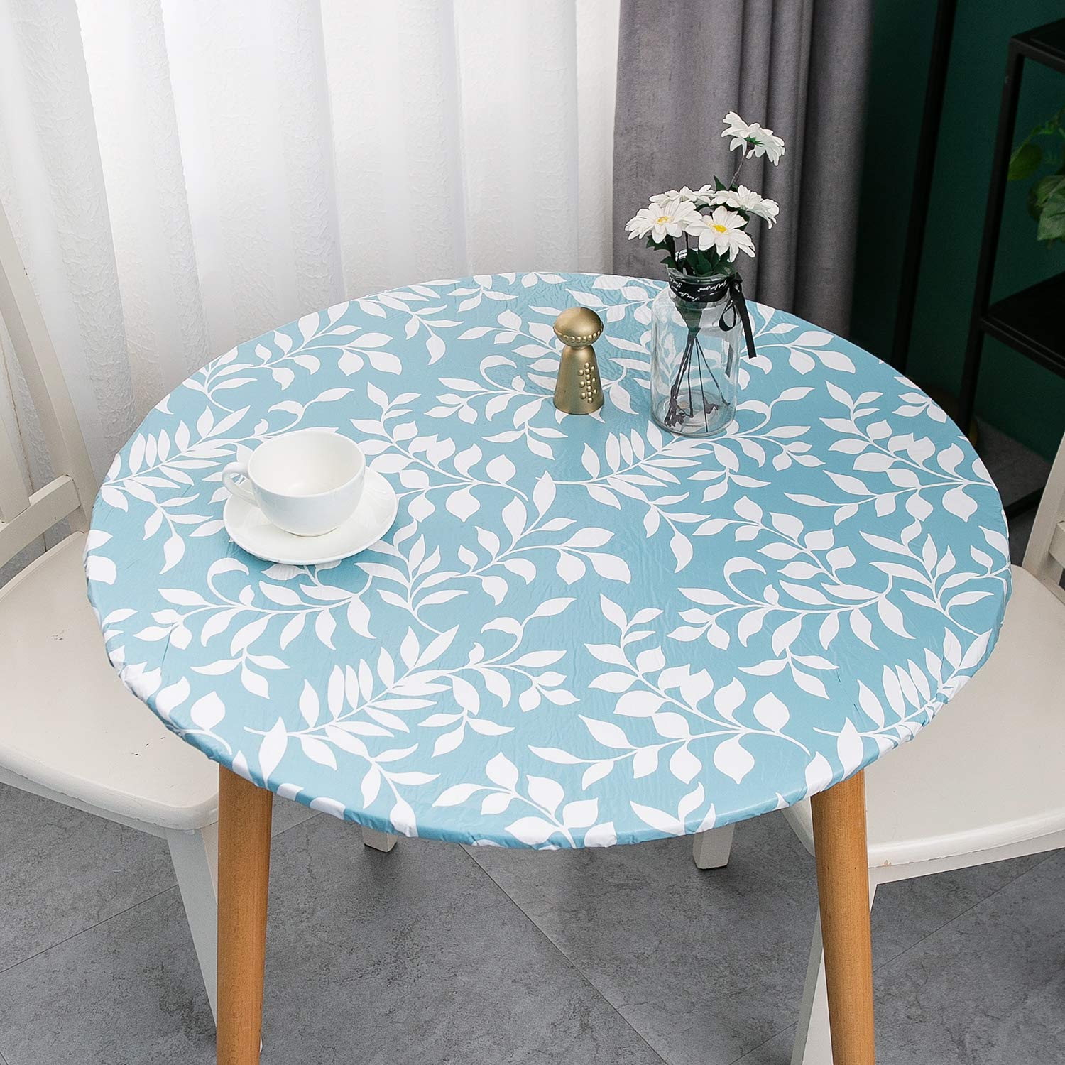 Pioggia round tablecloth with flannel backing protects surfaces softly.