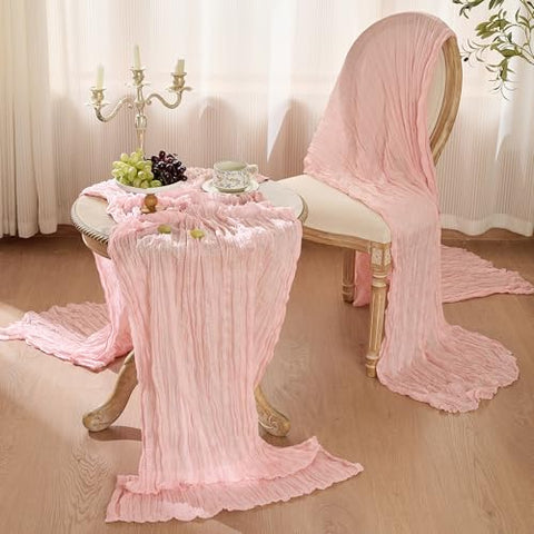 Playieer dusty-pink runner paired with candles and florals for elegant centerpieces.