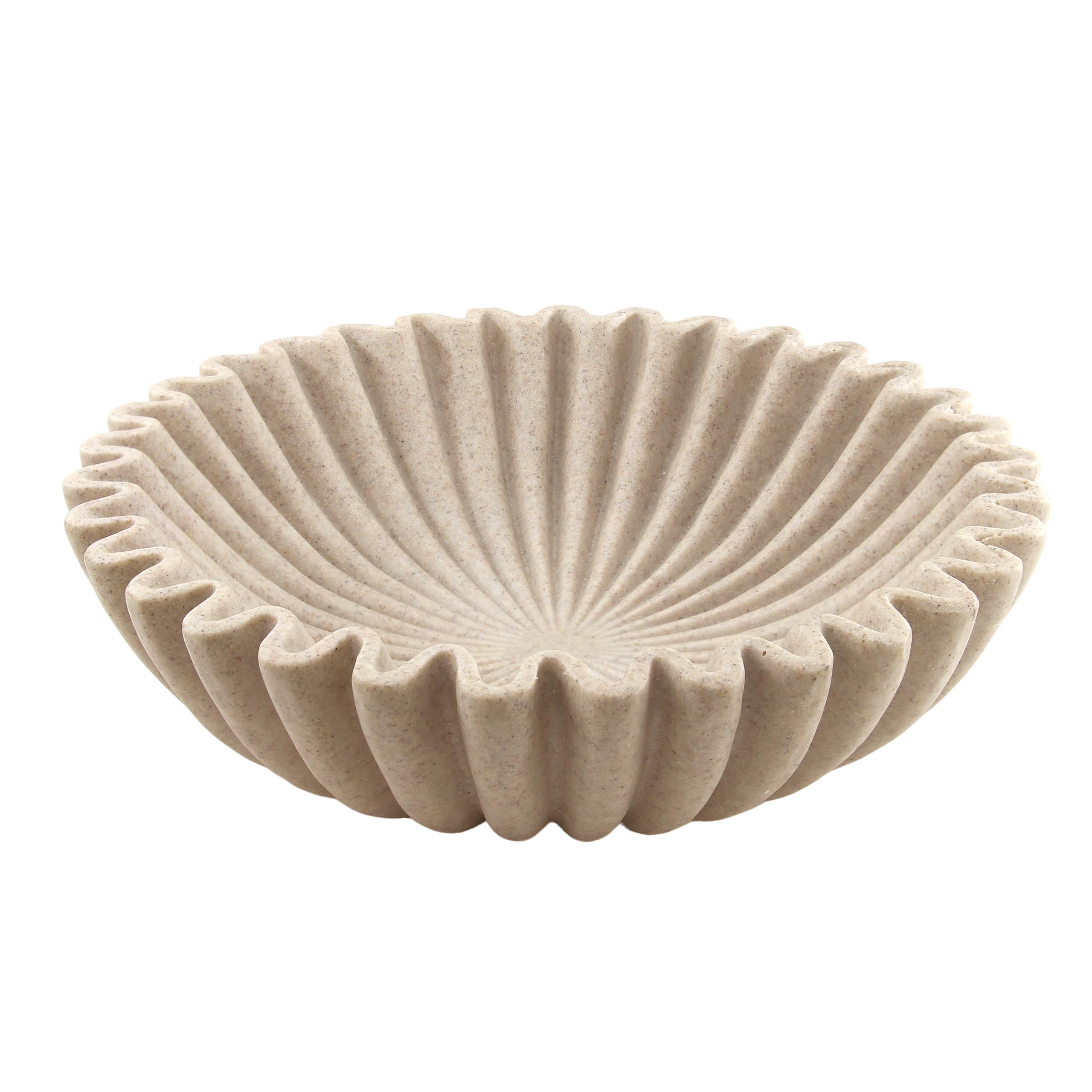 Plukers large beige ruffle bowl on a coffee table showcasing modern decor