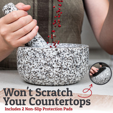 Elegant white granite mortar and pestle displayed on a kitchen counter.