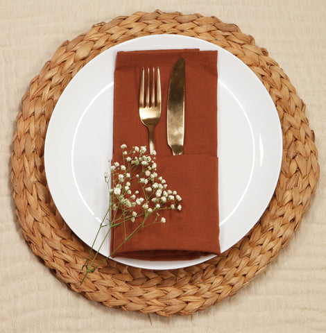 PurpleEssences rust napkins in a farmhouse-style setting, ideal for gatherings and family meals.