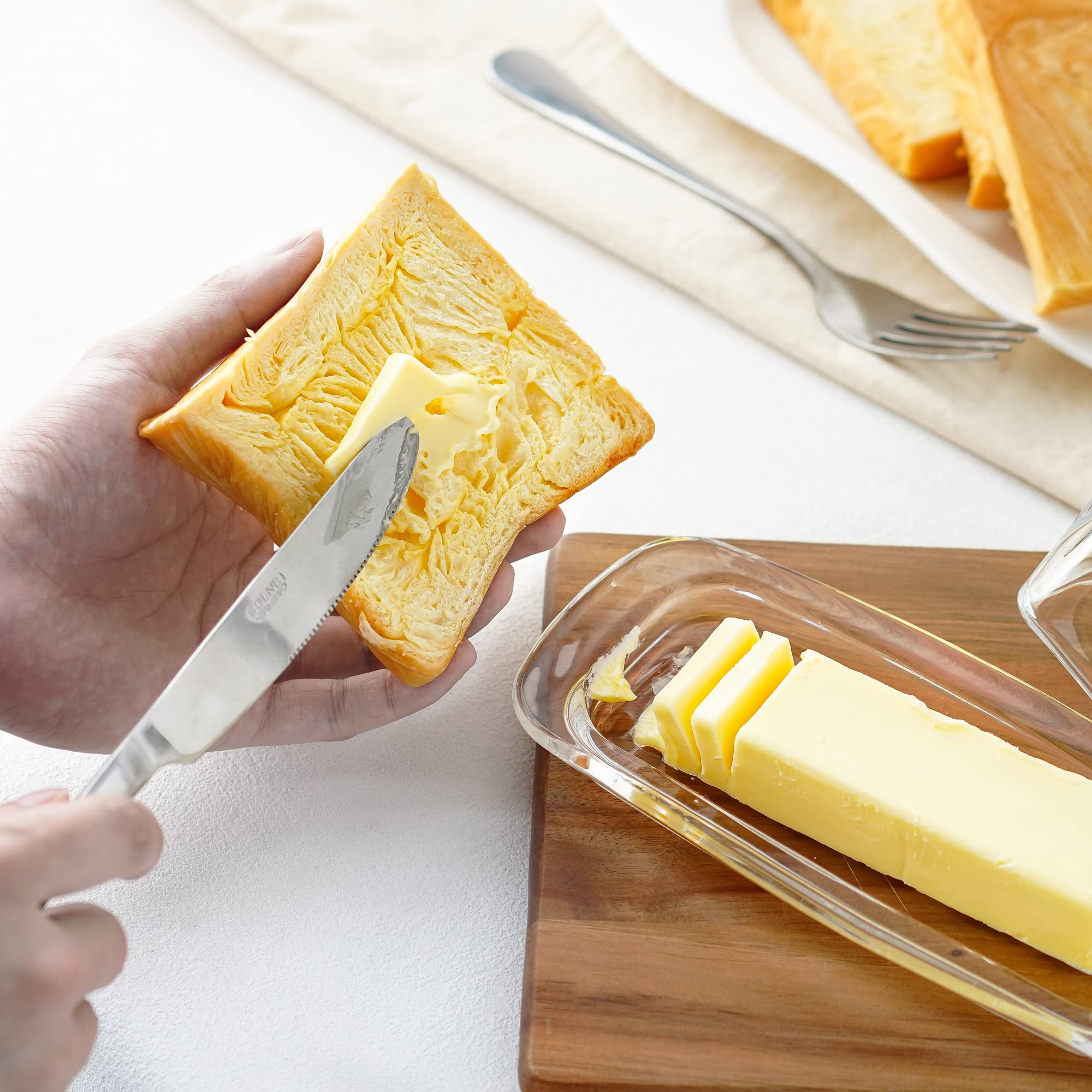 Elegant glass presentation for serving butter or small spreads.