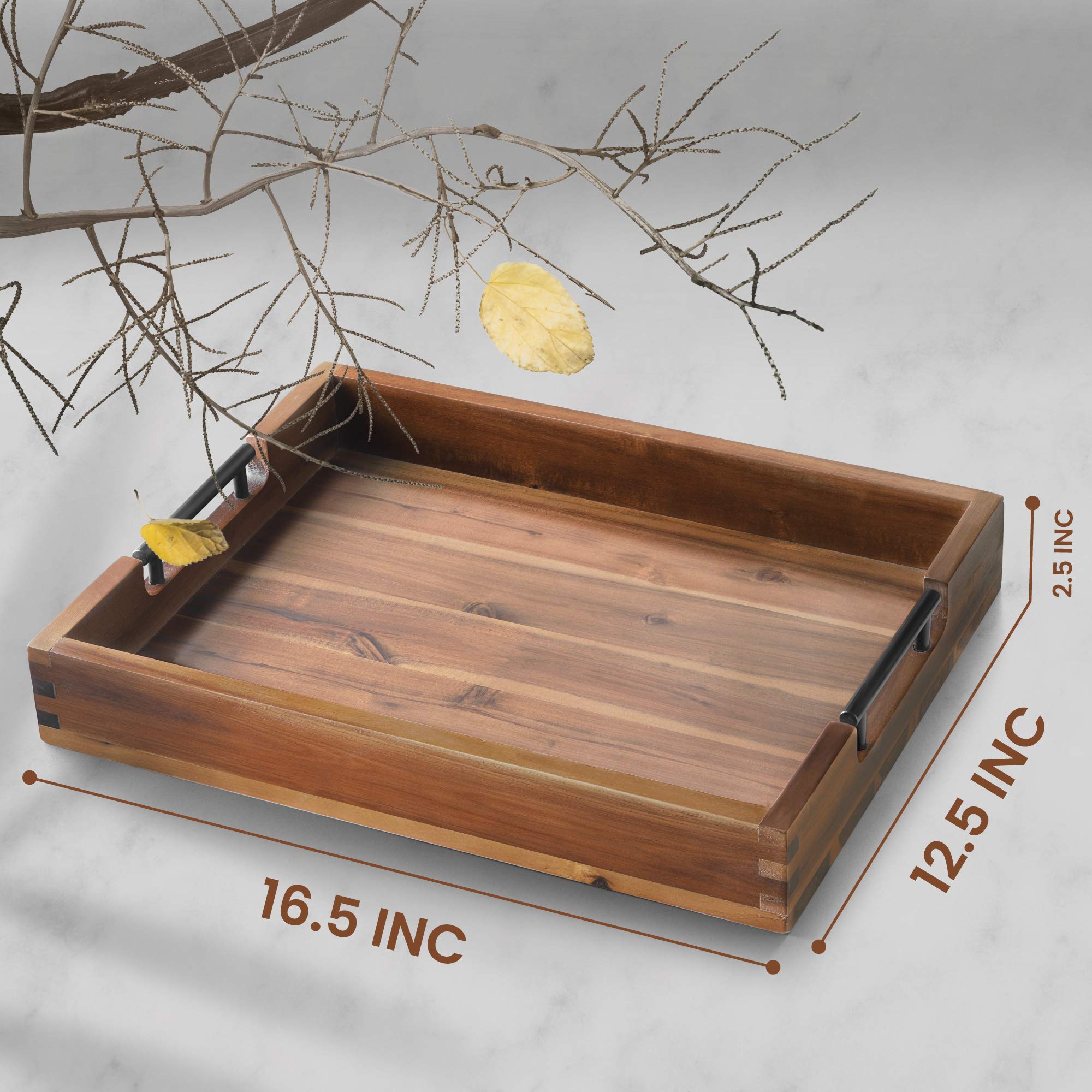 RAKYTO serving tray with metal handles on sturdy acacia wood surface for cups and snacks.