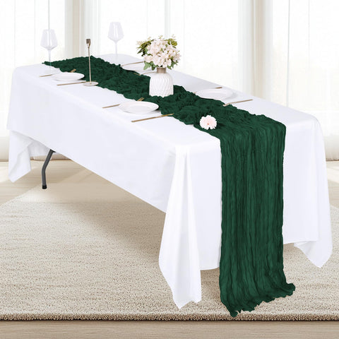 Emerald green gauze fabric drapes gracefully over tables.