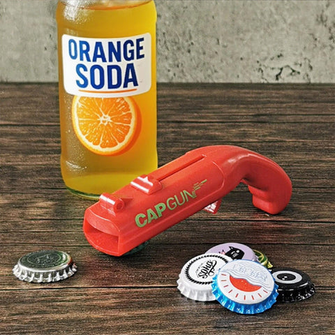 Redomm cap gun opener on table, ready to entertain guests at a barbecue.
