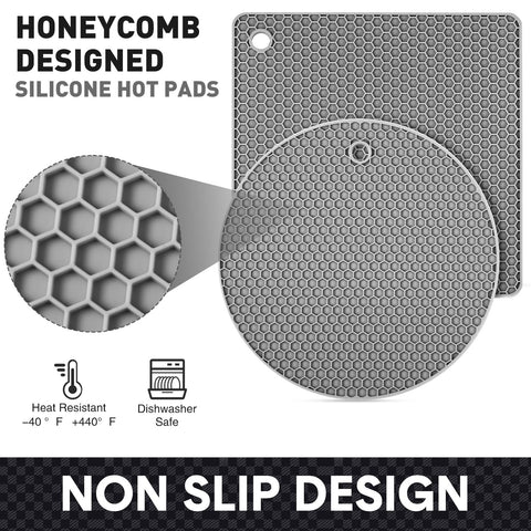 Remagr round black silicone trivets prevent heat damage on dining surfaces.