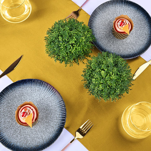 REWOMC round table with gold satin runner adds formal decor touch.