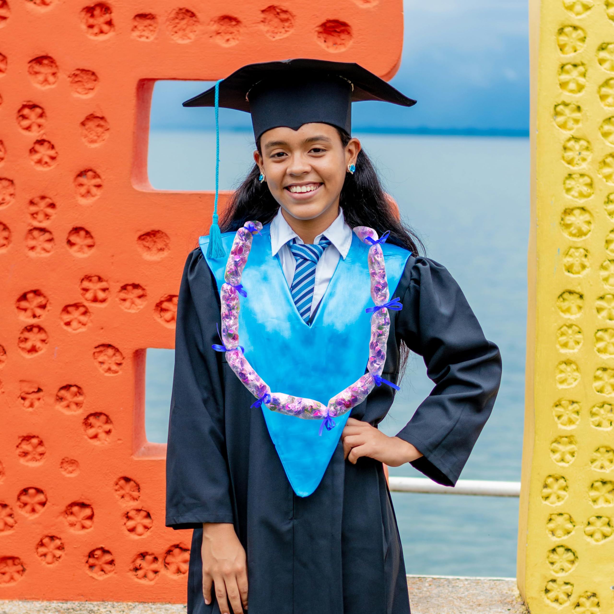 Rodudu Candy Lei Kit tying ribbons to finish sections and decorate leis.
