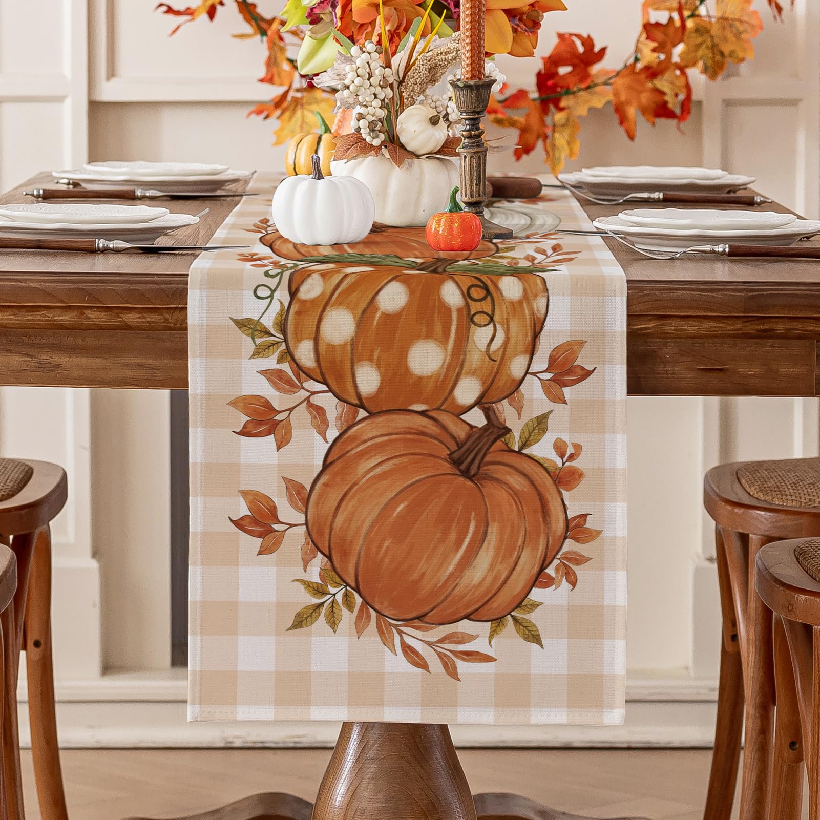 Romanstile pumpkin leaves fall table runner on a warm autumn dining table.