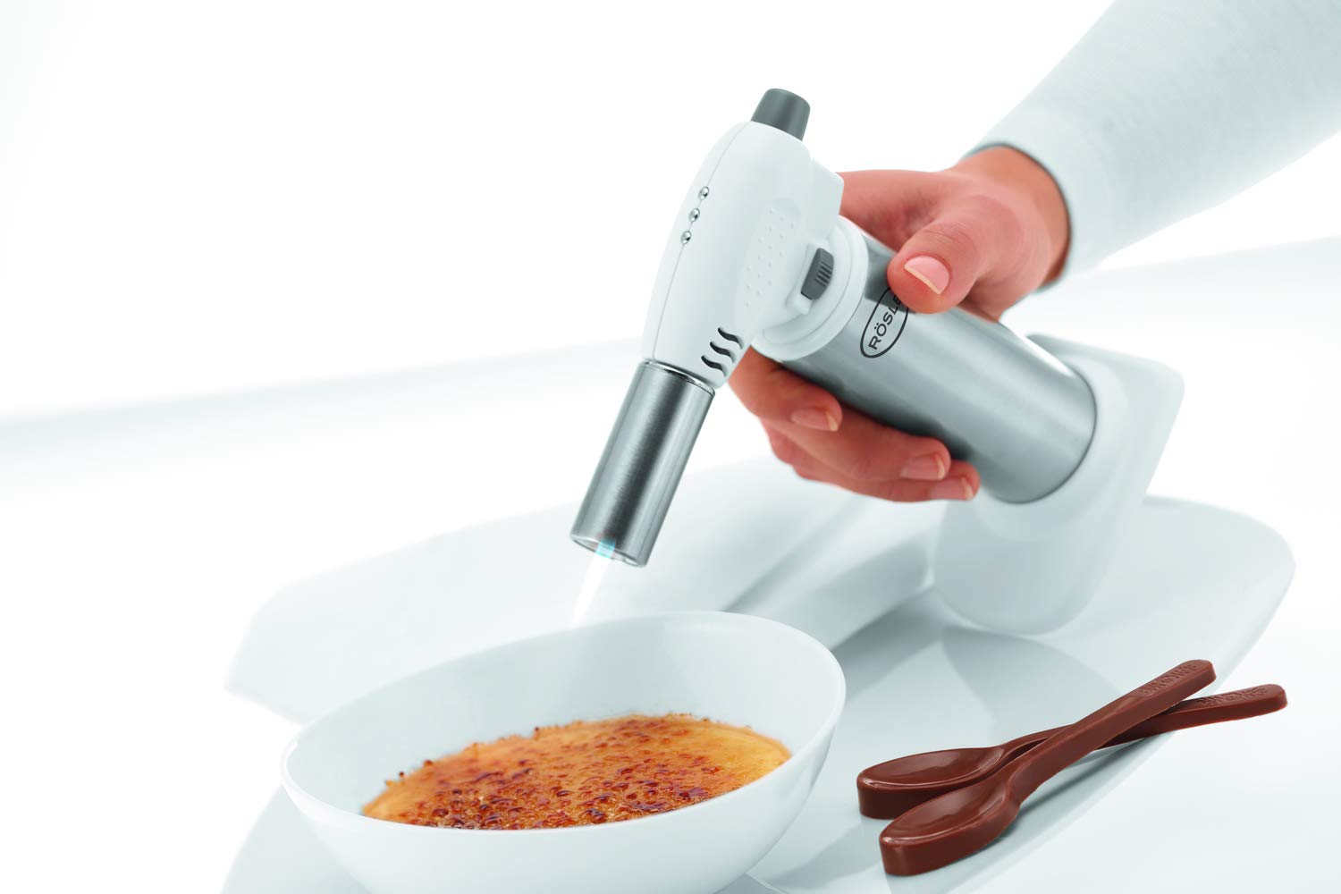 Rösle torch caramelizing creme brulee for a crisp, even finish