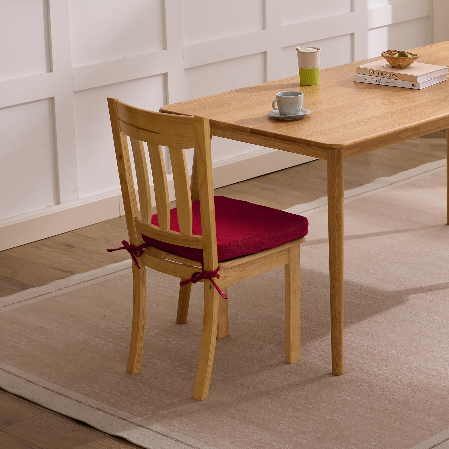 Ruqmuis dining room setup with red chair cushions