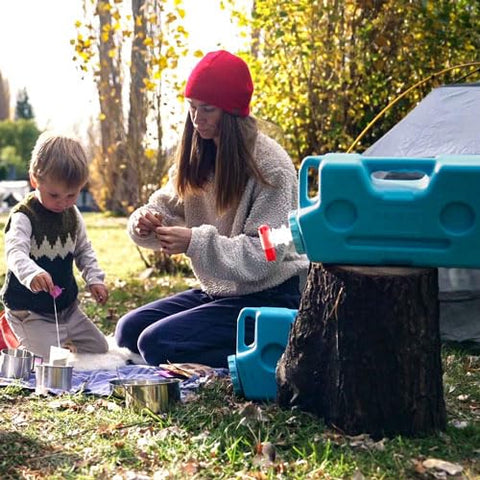 Pouring beverages from AquaBrick with spigot, ideal for camping and picnics.