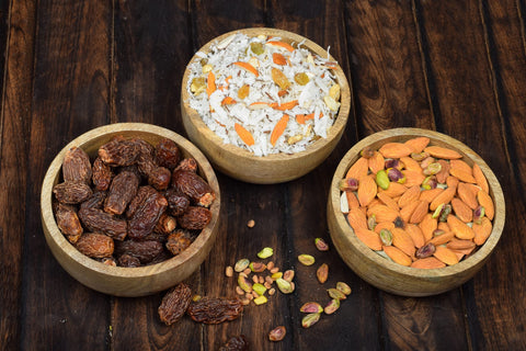 Samhita mango wood round bowl with olives and dip for appetizers.