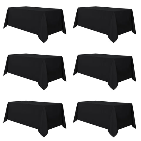 Sancua 6-pack black tablecloths covering a 6ft dining table for events and easy cleanup.