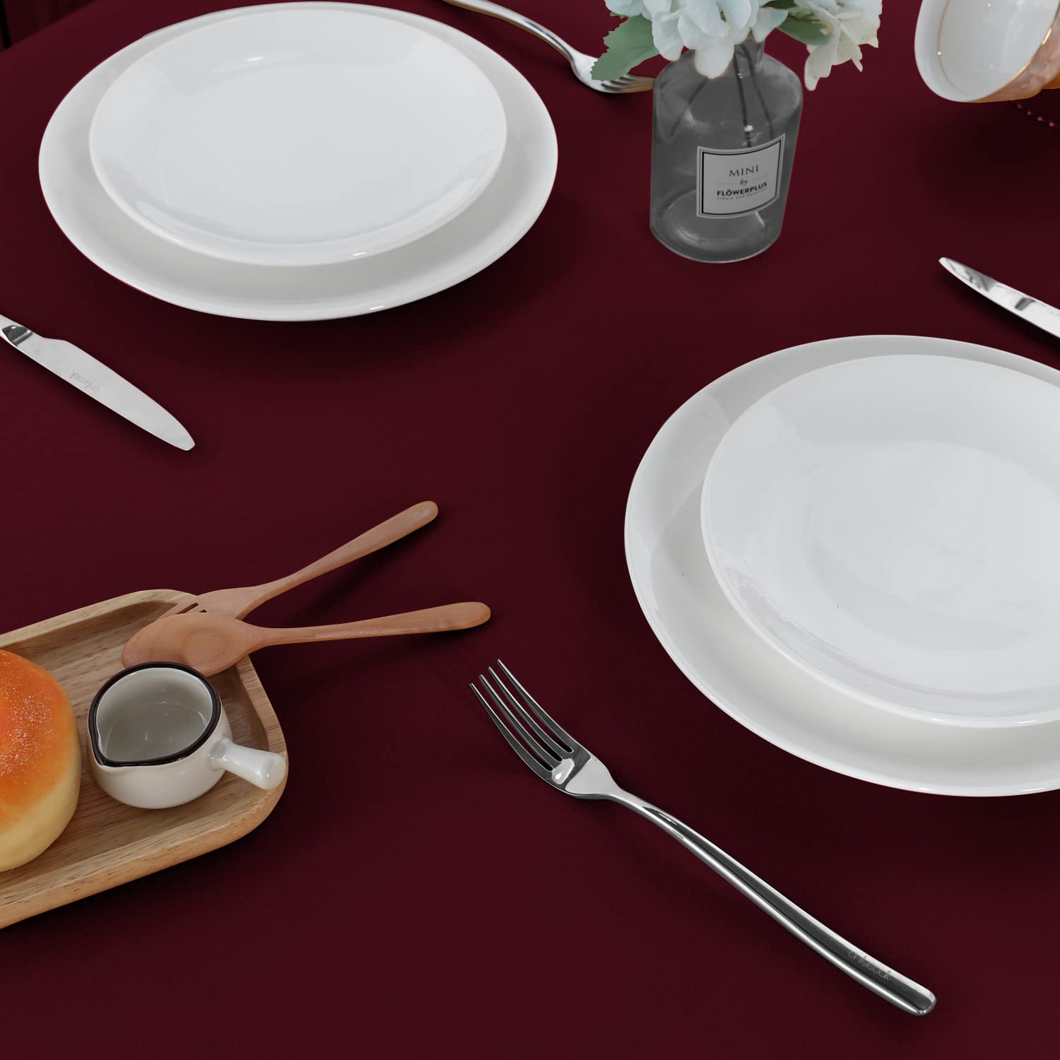 Sancua burgundy tablecloth at a buffet or dining setting, highlighting durability.