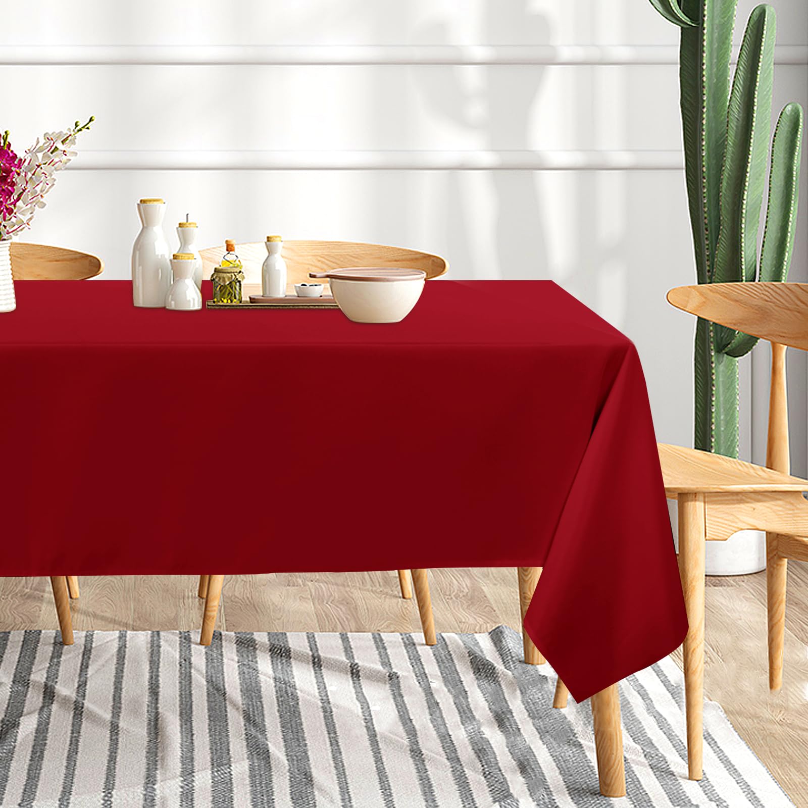 Sancua dining table setup with red tablecloth showcasing vibrant color and elegant drape.