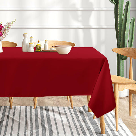 Sancua dining table setup with red tablecloth showcasing vibrant color and elegant drape.