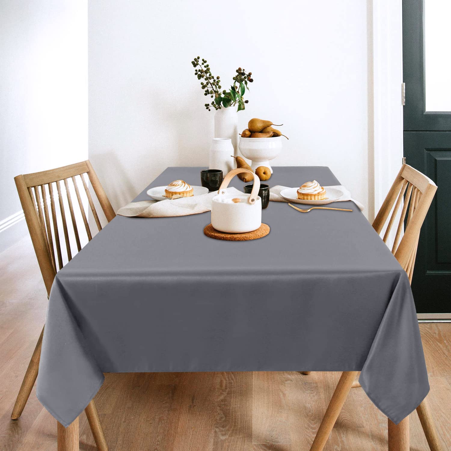 Sancua light grey tablecloth 60x102 on a dining table with settings, creating an elegant backdrop.