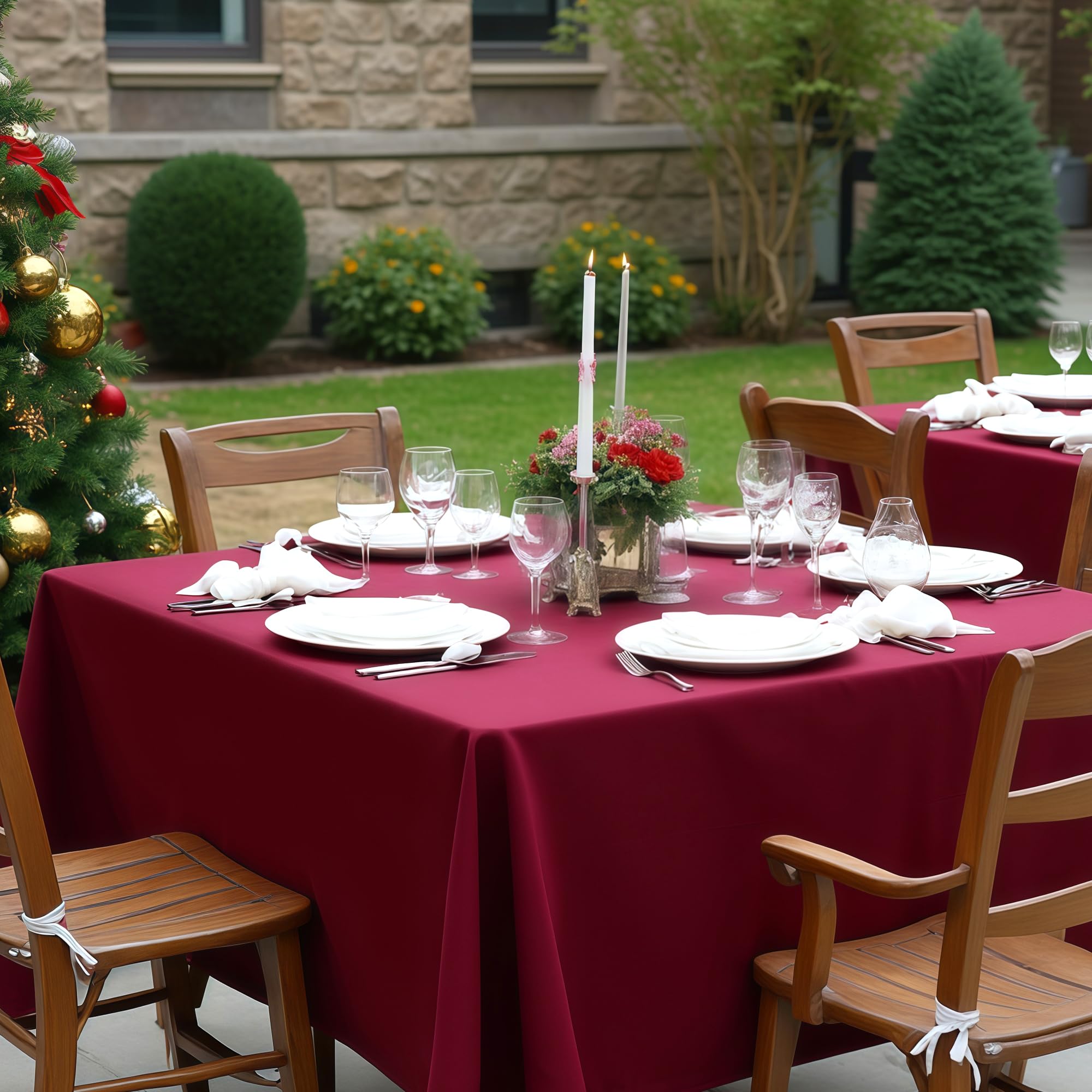 Sancua burgundy tablecloth draped on a round and square table.