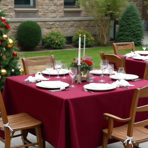 Sancua burgundy tablecloth draped on a round and square table.