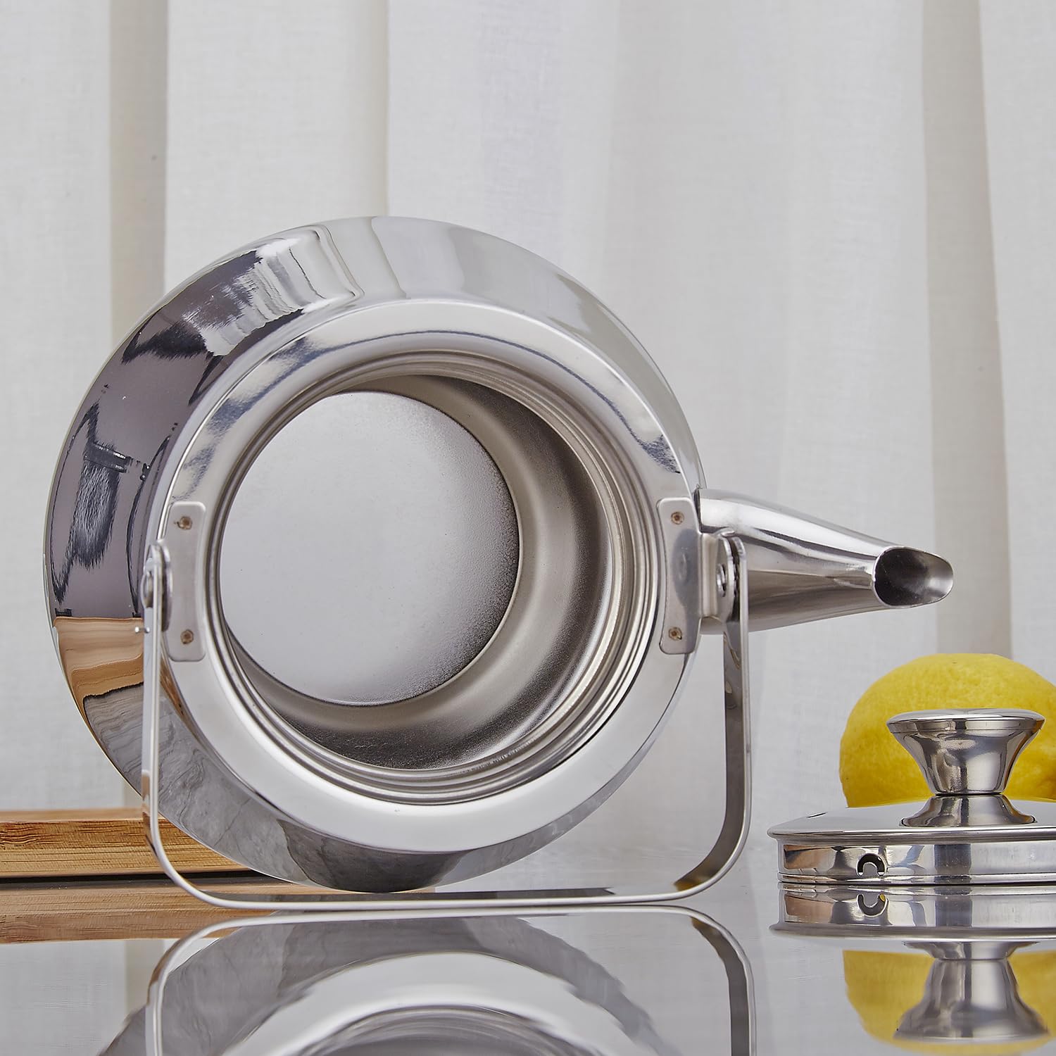 SANQIAHOME teapot on a gas stove for steady heating.