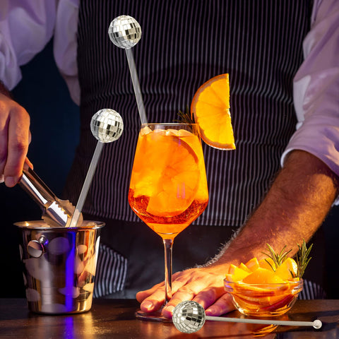 Sawysine party stirrers sparkle under lights, drawing attention to drinks.