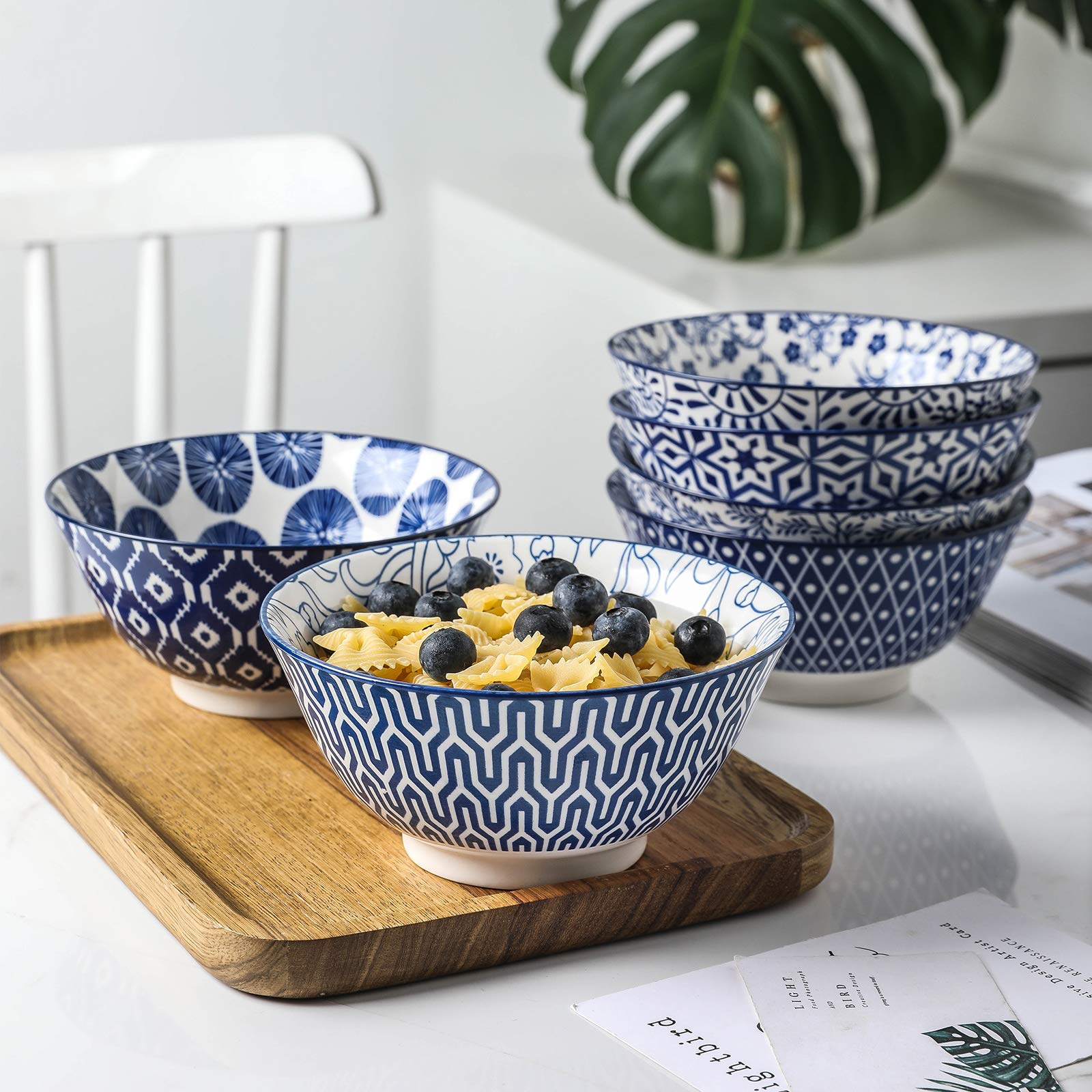Selamica bowls display vintage blue pattern, great for salads and pasta.
