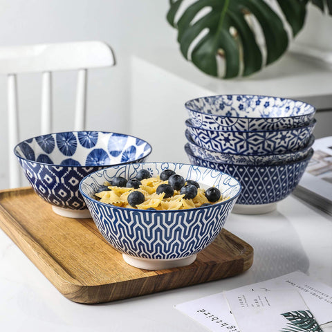 Selamica bowls display vintage blue pattern, great for salads and pasta.