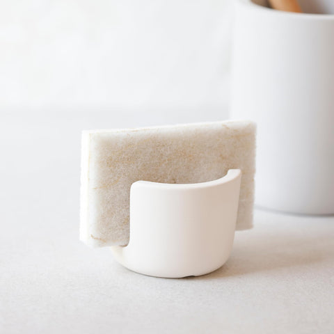 Selegna sponge holder with sponges shows organized, hygienic counter workspace.