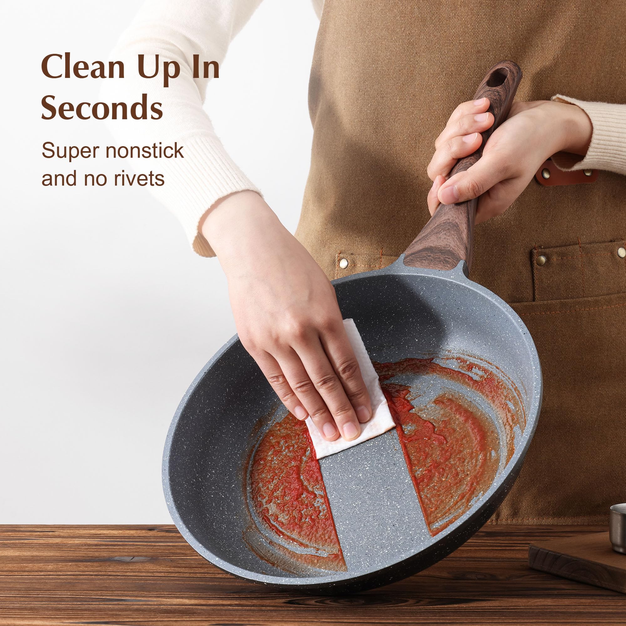SENSARTE nonstick skillet being wiped for quick cleaning after cooking.