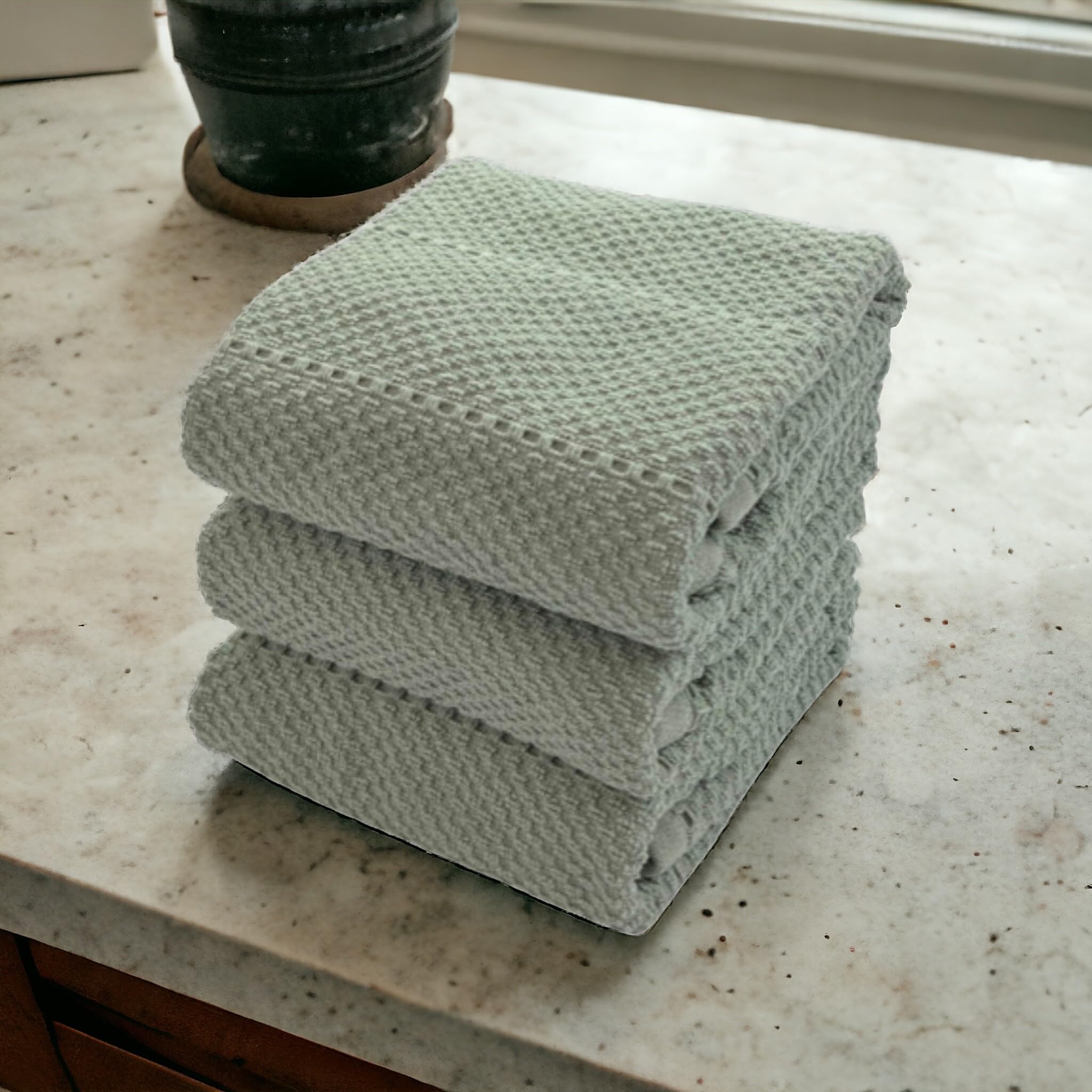 Serafina Home Sage Green towels hanging from loop for easy storage