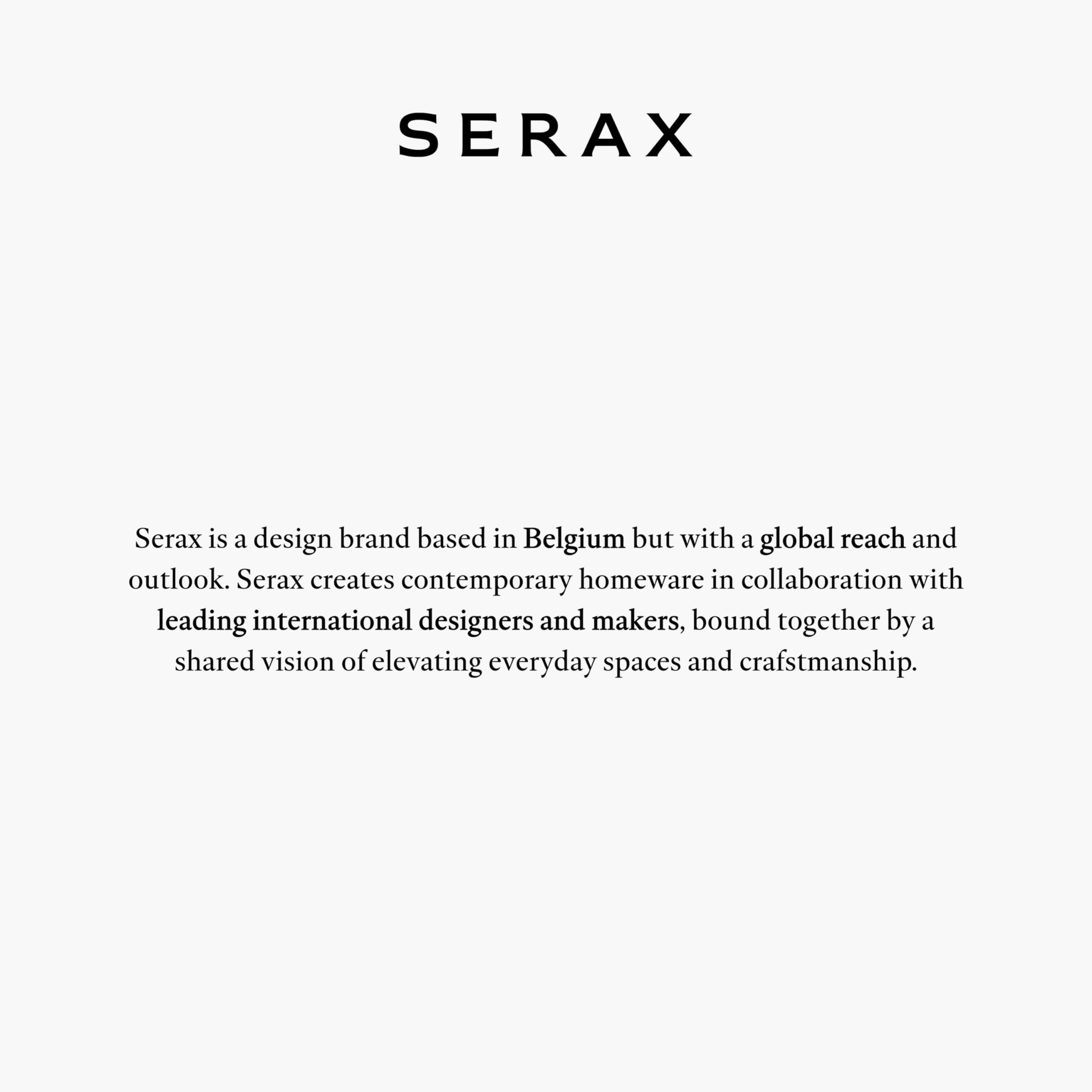 Serax pitcher used as a vase with fresh flowers for a stylish table.