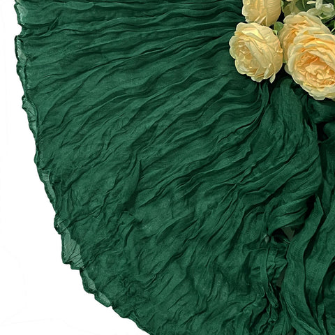Seveups emerald green cheesecloth runner set up for ceremonial tables.