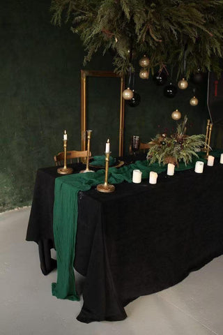 Seveups emerald green cheesecloth runner stretched across a long banquet table.