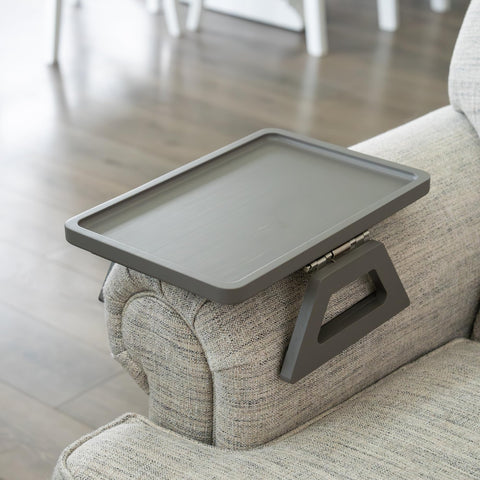 Shamrock Home Bamboo Trayble on a sofa arm provides a stable surface for drinks and remotes.