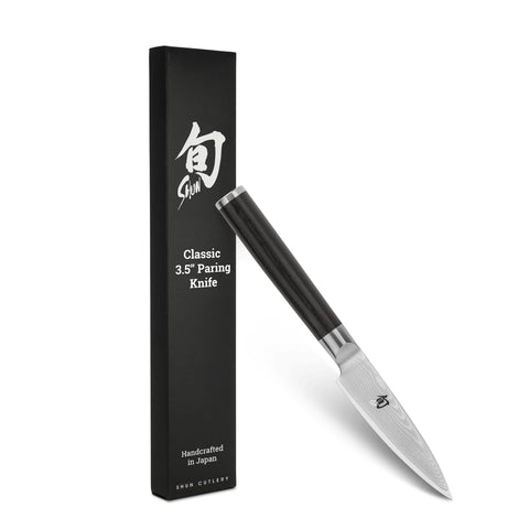 Shun Classic paring knife blade close-up showing razor-sharp edge for precise peeling.