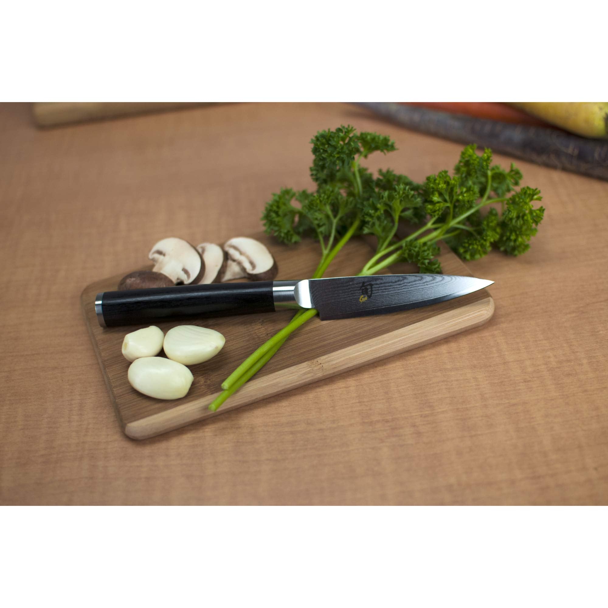 Shun Classic paring knife with D-shaped Pakkawood handle for comfortable control.