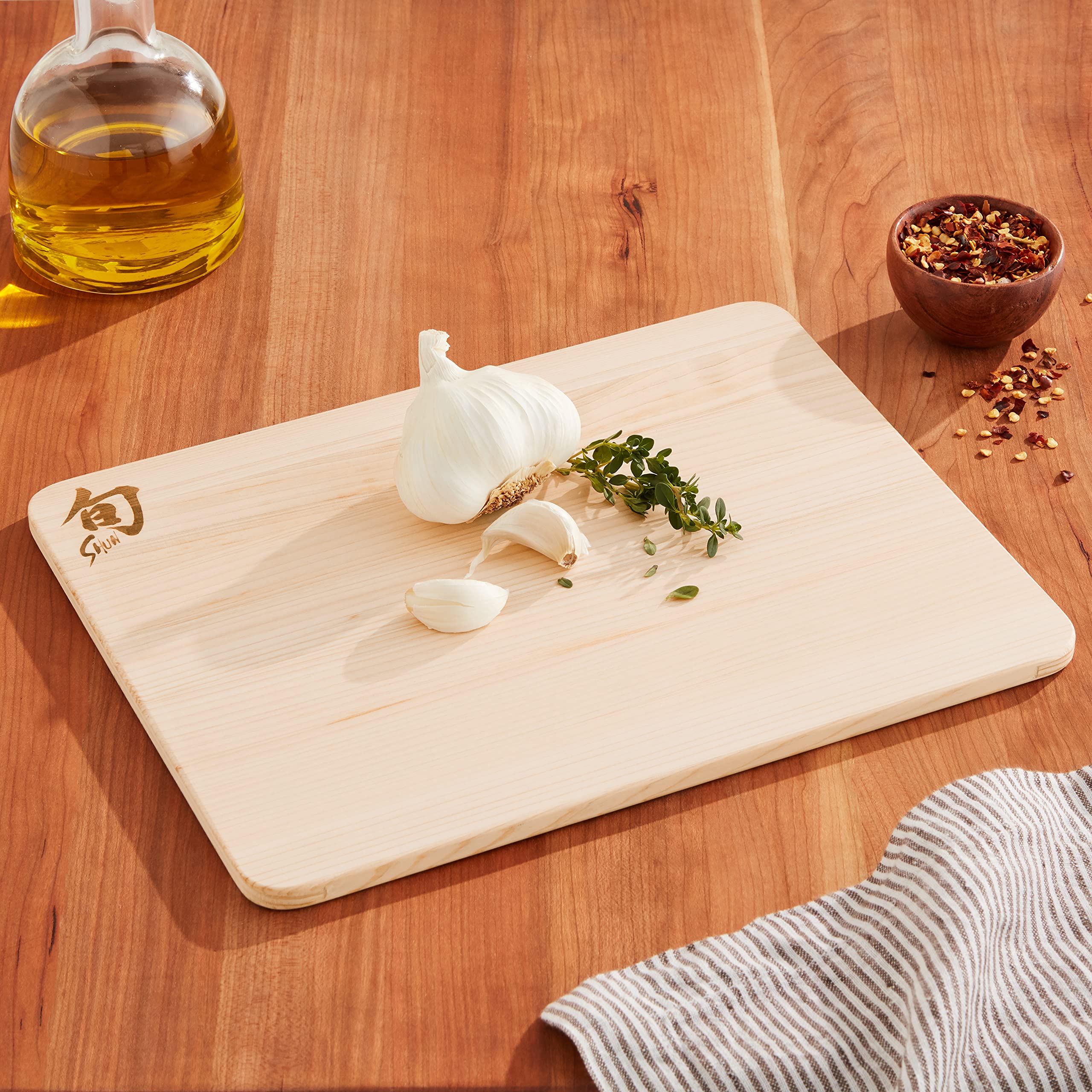 Shun Hinoki small cutting board surface close-up shows smooth grain for gentle slicing