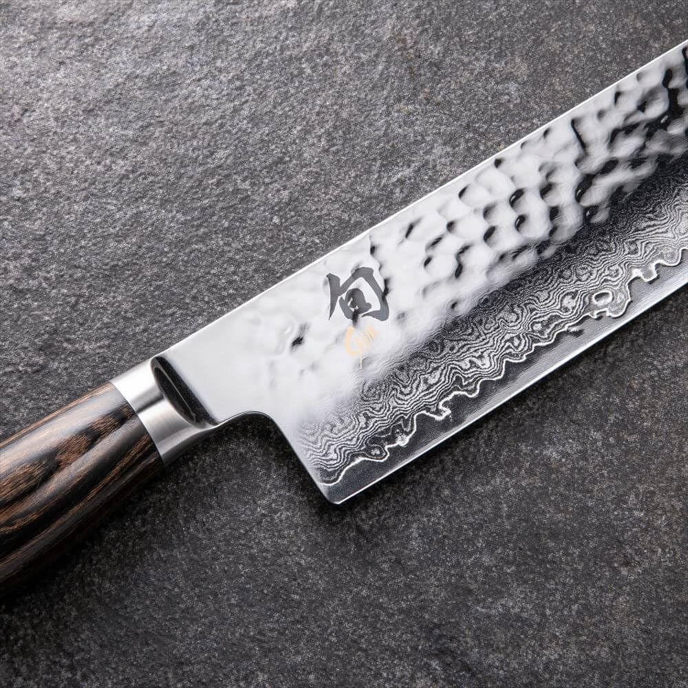 Shun Premier Nakiri in use slicing vegetables evenly.