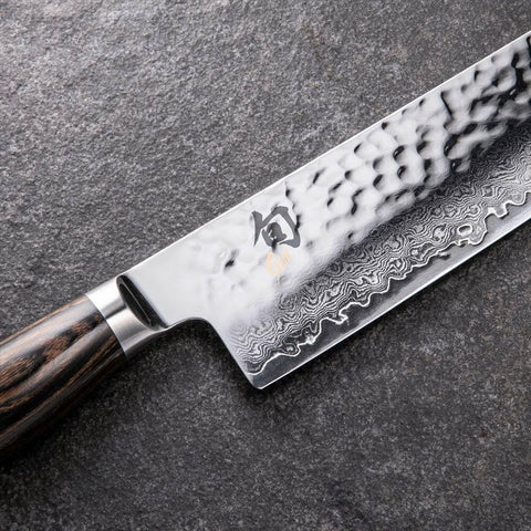 Shun Premier Nakiri in use slicing vegetables evenly.