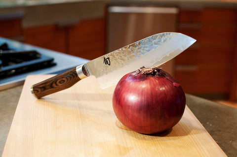 Shun Premier Santoku with hammered Tsuchime finish promotes easy food release.