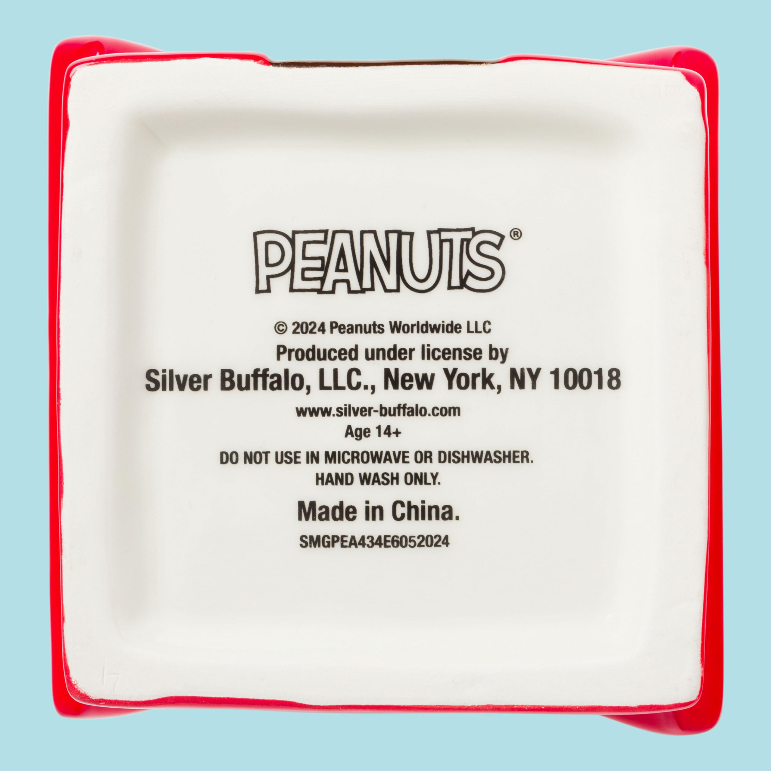 Silver Buffalo Peanuts cookie jar shelf display; enhances Peanuts decor while storing treats.