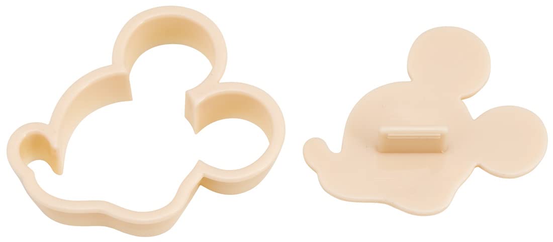 Dough is pressed into Mickey shapes using Skater molds.